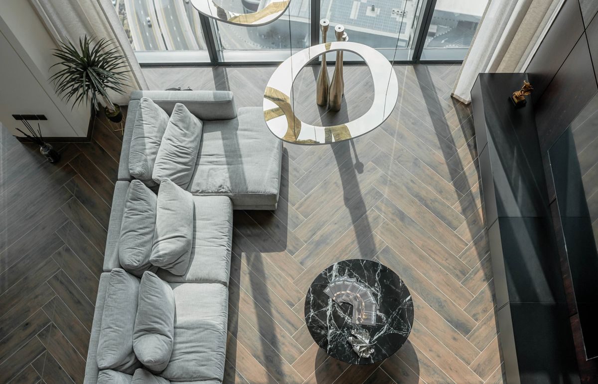 Visualisation of a living room with a low sofa on herringbone oak